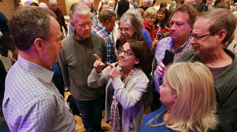 David Birdwell, a presenter who backs the proposed City of East Cobb, is confronted by Nancy Miller and other local residents with questions at the conclusion of a packed town hall meeting in Nolan Hall at the Catholic Church of St. Ann on Thursday, March 28, 2019, in Marietta.    Curtis Compton/ccompton@ajc.com