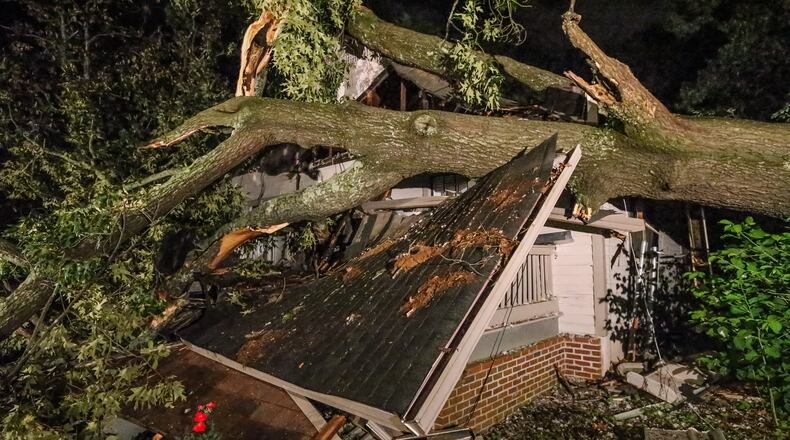One tree fell and crushed the front area of a house Wed. May 4, 2016 in southeast Atlanta on Wilbur Avenue. JOHN SPINK / JSPINK@AJC.COM