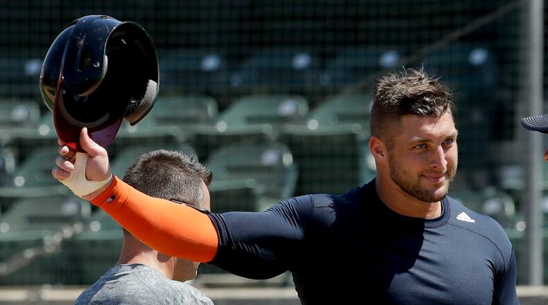 Former NFL quarterback, Tim Tebow finishes his work out for baseball scouts and the media during a showcase on the campus of the University of Southern California, Tuesday, Aug. 30, 2016 in Los Angeles. The Heisman Trophy winner works out for a big gathering of scouts on USC's campus in an attempt to start a career in a sport he hasn't played regularly since high school. (AP Photo/Chris Carlson)