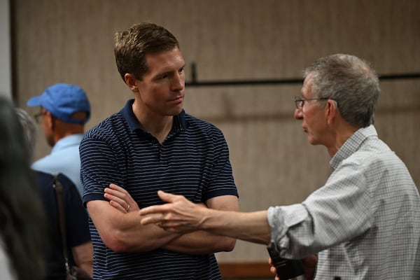 Conor Lamb listens to a participant after he spoke to the crowd at a town hall-style event organized by progressive groups at Central Penn College, Sunday, June 22, 2025, in Enola, Pa. (AP Photo/Marc Levy)
