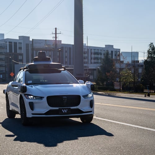A Waymo self-driving taxi travels down Northside Drive in Atlanta on Thursday, Dec. 11, 2025. (Ben Hendren for the AJC)