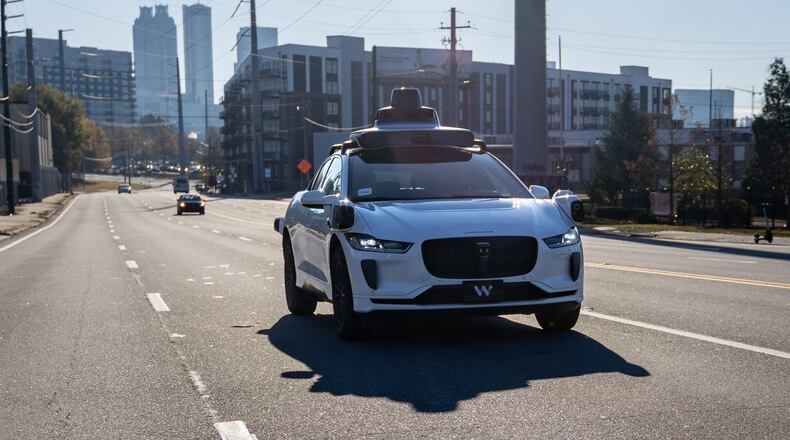 A Waymo self-driving taxi travels down Northside Drive in Atlanta on Thursday, Dec. 11, 2025. (Ben Hendren for the AJC)