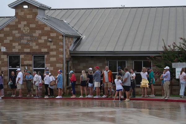 Families line up at a reunification center after flash flooding it the area, Friday, July 4, 2025, in Ingram, Texas. (AP Photo/Eric Gay)