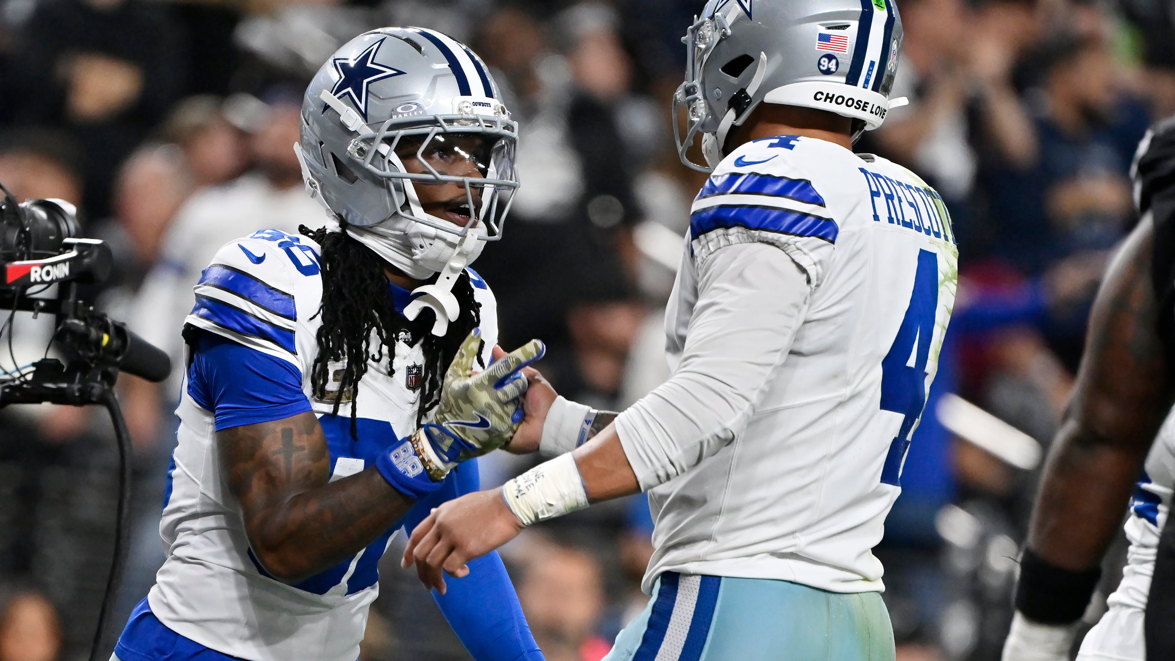 Dallas Cowboys wide receiver CeeDee Lamb, left, celebrates his touchdown against the Las Vegas Raiders with Cowboys quarterback Dak Prescott (4) during the first half of an NFL football game Monday, Nov. 17, 2025, in Las Vegas. (AP Photo/David Becker)
