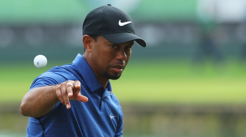 Tiger Woods throws his ball to caddie Joe LaCava on the 9th green during the first round of the Omega Dubai Desert Classic at Emirates Golf Club Feb.  2, 2017 in Dubai, United Arab Emirates.