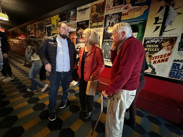 On Dec. 23, 2025, Plaza Theatre owner Christopher Escobar (left) welcomes Anita and John Strickler to the theater, where they think they had their first date in 1959. (Rodney Ho/AJC)