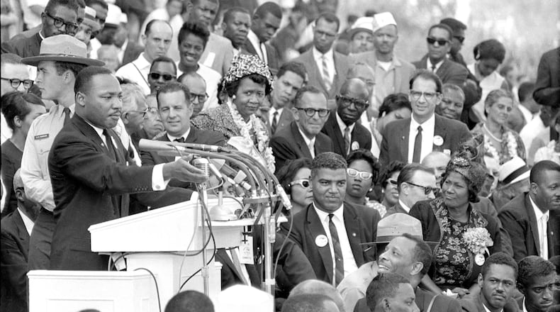 The Rev. Dr. Martin Luther King Jr., head of the Southern Christian Leadership Conference, gestures during his "I Have a Dream" speech as he addresses thousands of civil rights supporters gathered in front of the Lincoln Memorial for the March on Washington for Jobs and Freedom in Washington, D.C., Aug. 28, 1963. Mahalia Jackson is sitting on the right side of the photo and actor-singer Sammy Davis Jr. can be seen at extreme right, bottom. (AP Photo)