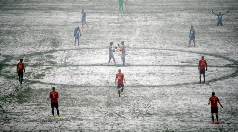 Atlanta United and Minnesota United prepare for an MLS soccer game as a grounds crew worker clear lines Sunday, March 12, 2017, in Minneapolis, Minn. (Jeff Wheeler/Star Tribune via AP)