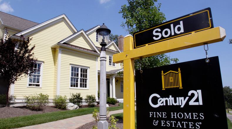 FILE - A sold sign is posted outside a newly constructed luxury home in Wellesley, Mass., Aug. 25, 2009. (AP Photo/Charles Krupa, File)