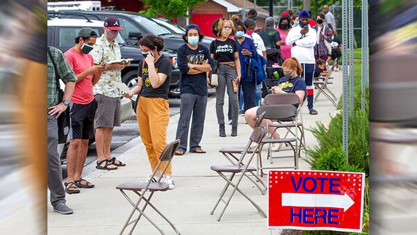 Voters wait in a line during the June primary that stretched around the Metropolitan Library.