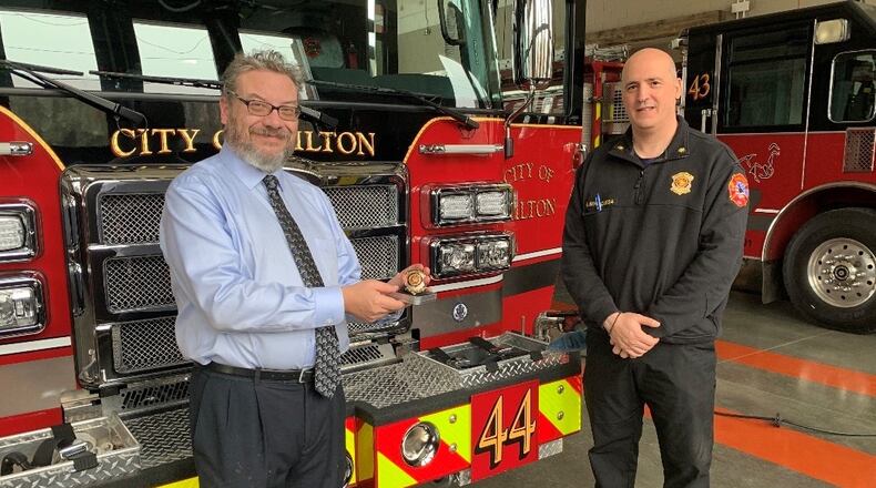 Milton Fire-Rescue Chief Gabe Benmoussa (right) presented Rabbi Bernstein with a Milton Fire badge in recognition of his becoming the department's new chaplain. (Courtesy City of Milton)