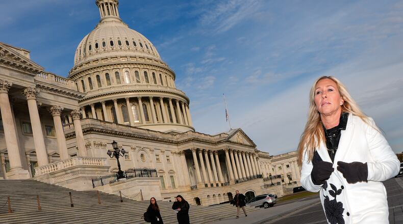 Marjorie Taylor Greene — pictured arriving at a news conference in November — resigned as a U.S. representative, and 22 candidates will face off in a special election to fill her seat March 10. If no candidate receives a majority of the vote, the top two will advance to a runoff April 7. (Julia Demaree Nikhinson/AP)