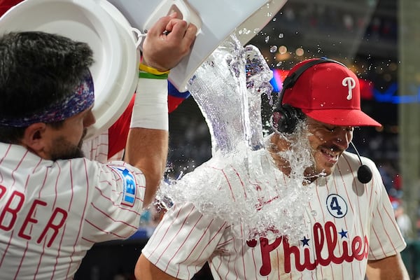 Philadelphia Phillies' Otto Kemp, right, is dunked by Kyle Schwarber after the Phillies won a baseball game against the Chicago Cubs Monday, June 9, 2025, in Philadelphia. (AP Photo/Matt Slocum)