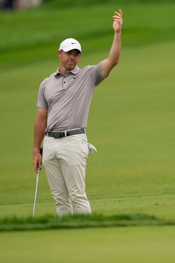 Rory McIlroy, of Northern Ireland, reacts as fans continue to move near the seventh green as he prepares to play his shot during the third round of the U.S. Open golf tournament at Oakmont Country Club Saturday, June 14, 2025, in Oakmont, Pa. (AP Photo/Carolyn Kaster)
