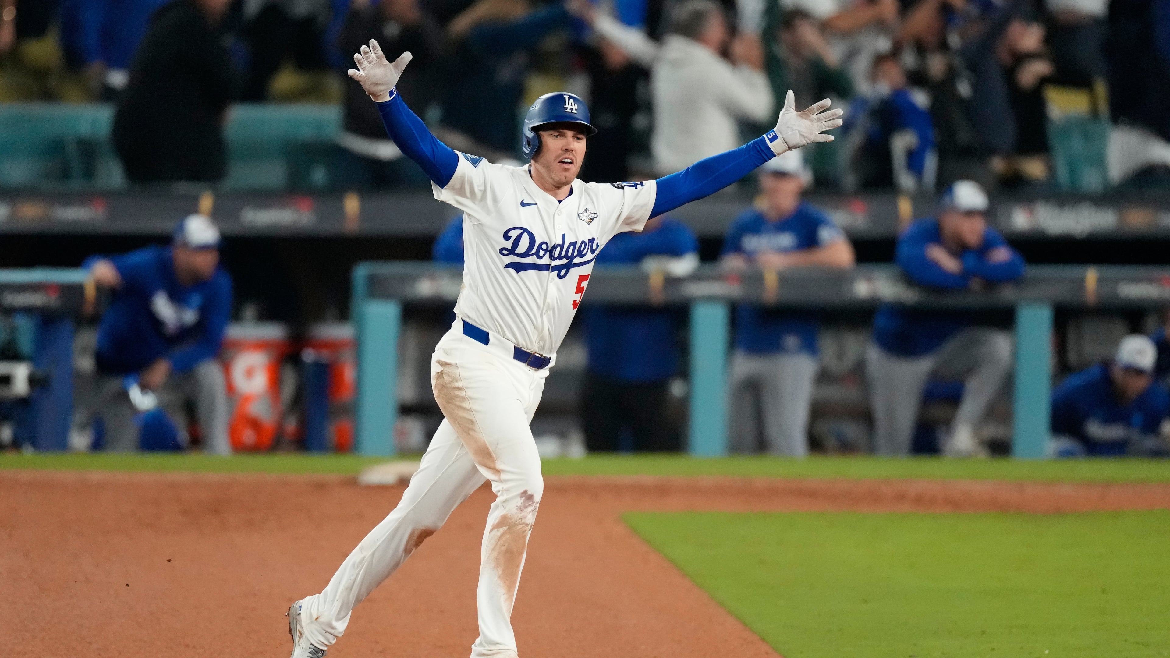 Los Angeles Dodgers' Freddie Freeman celebrates his walk off home run against the Toronto Blue Jays during the 18th inning in Game 3 of baseball's World Series, Monday, Oct. 27, 2025, in Los Angeles. (AP Photo/Mark J. Terrill)