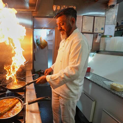 Chef Mohammed Shanoor Ali cooks at a Bangladeshi restaurant in London, Thursday, June 18, 2026. (AP Photo/Kin Cheung)