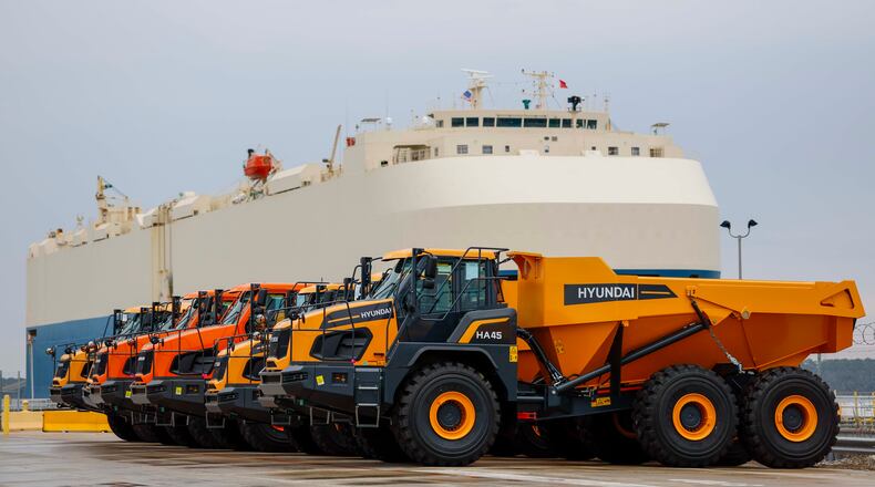 Dump trucks are parked as a ship prepares to depart the Georgia Port Authority in Brunswick, Ga., on Wednesday, Jan. 14, 2026. The GPA has invested in import-export facilities at its Brunswick terminal for heavy equipment manufacturers, including roll-in and roll-out, and a roofed facility for final assembly. (Miguel Martinez/AJC)