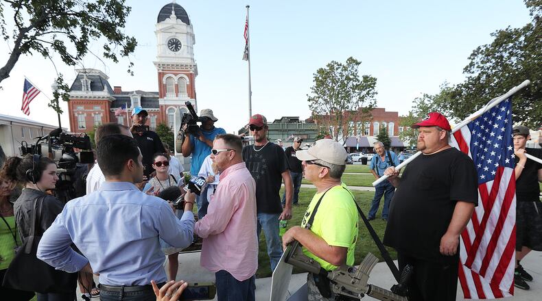 Chris Hill, leader of the III% Georgia Security Force, speaks to the news media during a protest held on the town square Tuesday, Sept. 13, 2016, in Covington against building a mosque in Newton County. Curtis Compton /ccompton@ajc.com