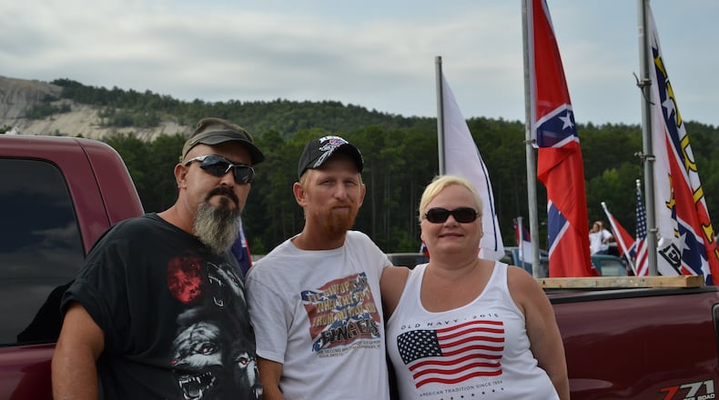 Joel Colston (left) and Dike Young pose for a photo with a friend at a Confederate flag rally at Stone Mountain Park on Friday, August 1, 2015. DANIEL FUNKE / DANIEL.FUNKE@COXINC.COM