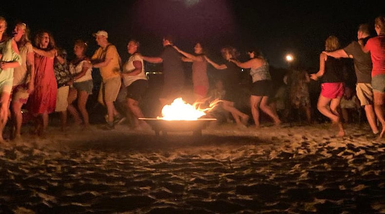 Members of the Apex Christian Singles dance around a campfire at their annual beach retreat in Panama City Beach.
(Courtesy of Debbie Perdue)