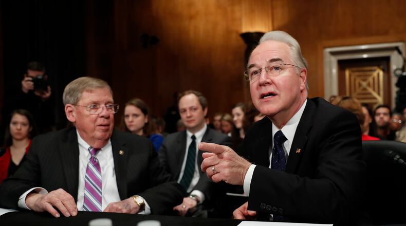 Health and Human Services Secretary nominee, Rep. Tom Price, R-Ga., accompanied by Sen. Johnny Isakson, R-Ga., who introduced him, speaks on Capitol Hill in Washington, Wednesday, Jan. 18, 2017, at his first Senate confirmation hearing . (AP Photo/Carolyn Kaster)