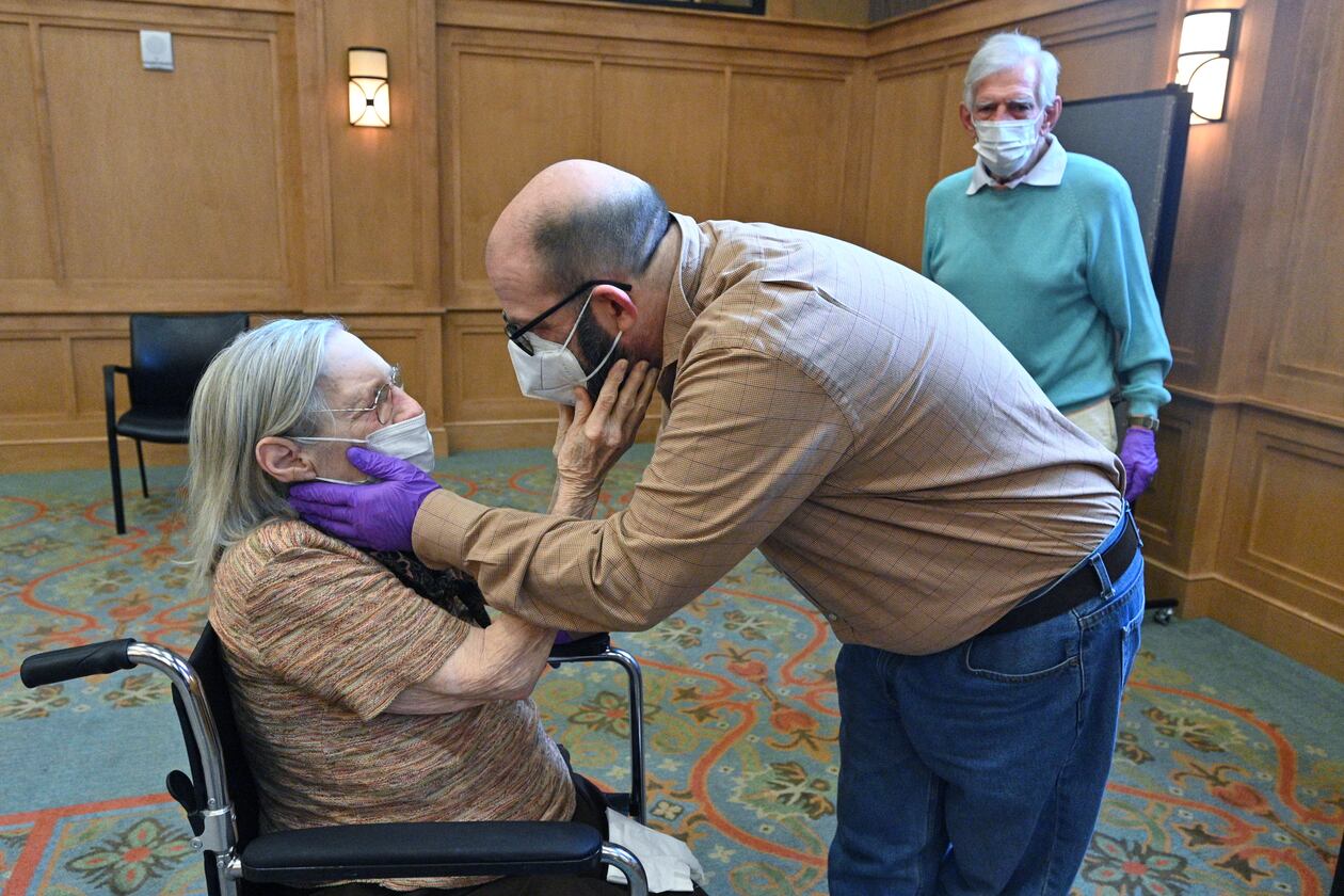 Connie Kendrick and her son, William Kendrick, embrace as they see each other at The William Breman Jewish Home in Atlanta on Thursday. (Hyosub Shin / Hyosub.Shin@ajc.com)