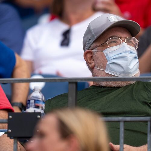A fan wears a mask during an air quality warning from wildfire smoke prior to baseball game between the New York Mets and the Philadelphia Phillies, Thursday, July 16, 2026, in Philadelphia. (AP Photo/Chris Szagola)