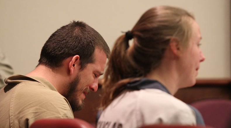 Jose Torres weeps in his seat while at the sentencing for his conviction on charges of street-gang terrorism, aggravated assault on Monday. His co-defendant, Kayla Norton, sits at his right. (Henry Taylor / henry.taylor@ajc.com)