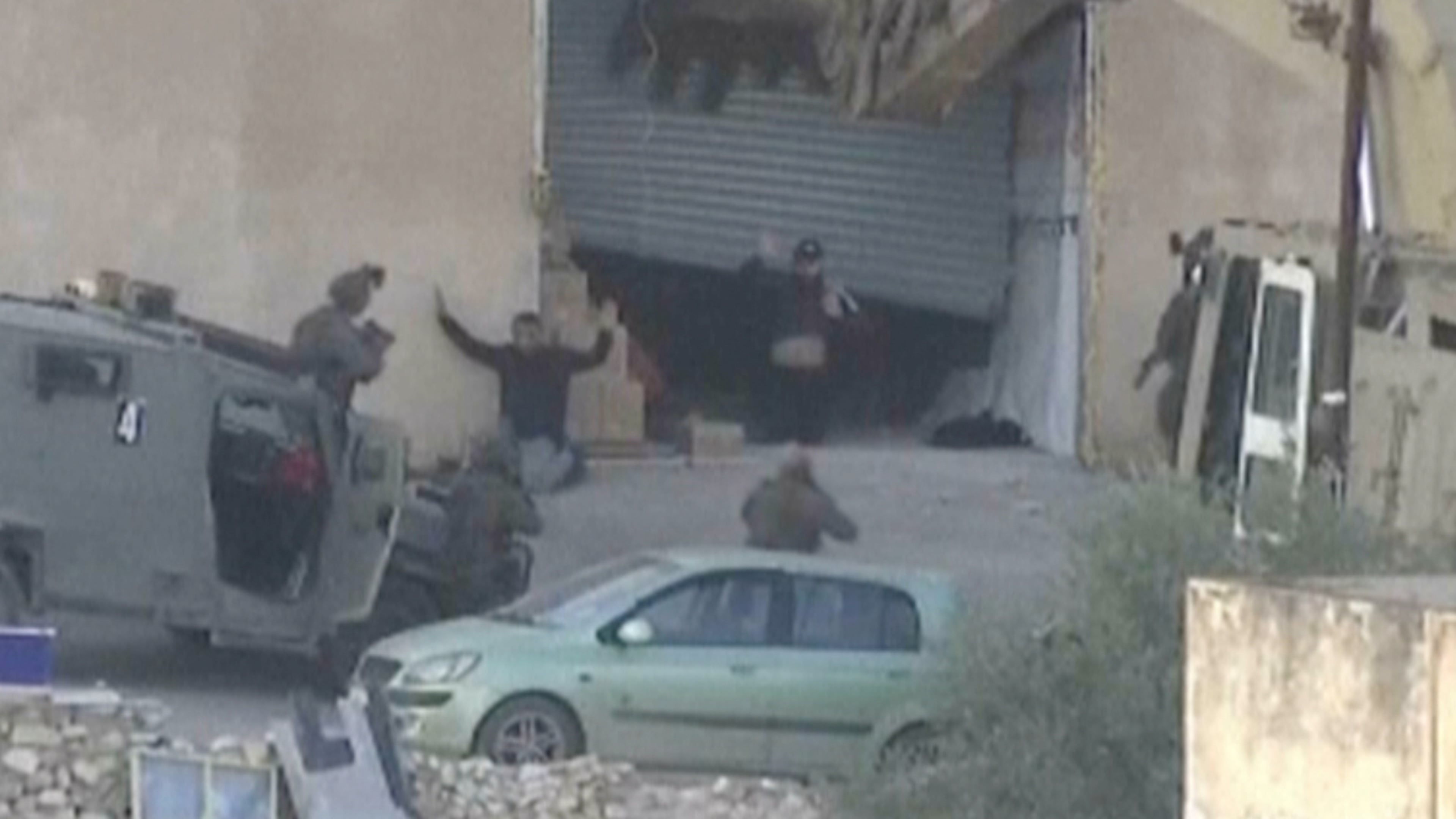 This image taken from video by Palestine TV shows two Palestinian men kneeling on the ground to Israeli forces shortly before they were shot dead during a military operation in Jenin, West Bank, on Thursday, Nov. 27, 2025. (Palestine TV via AP)