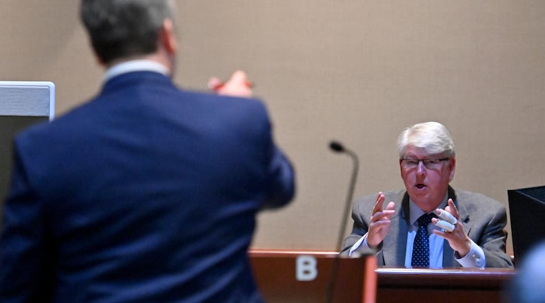 Brian K. Pritchard testifies on the witness stand Friday as Senior Assistant Attorney General Russell Willard, foreground, asks questions in a Gilmer County courtroom in Ellijay. Pritchard, a talk show host and Republican Party vice chairman, is accused of voting illegally while he was serving a felony sentence. (Hyosub Shin / Hyosub.Shin@ajc.com)