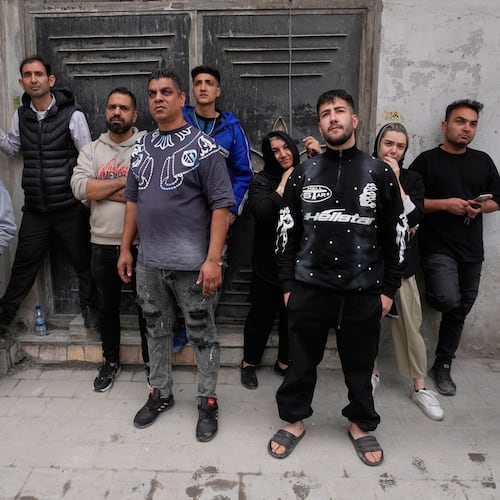 Residents look on as first responders inspect the rubble and search for victims at a residential building hit in an earlier U.S.-Israeli strike in Tehran, Friday, March 27, 2026. (AP Photo/Vahid Salemi)
