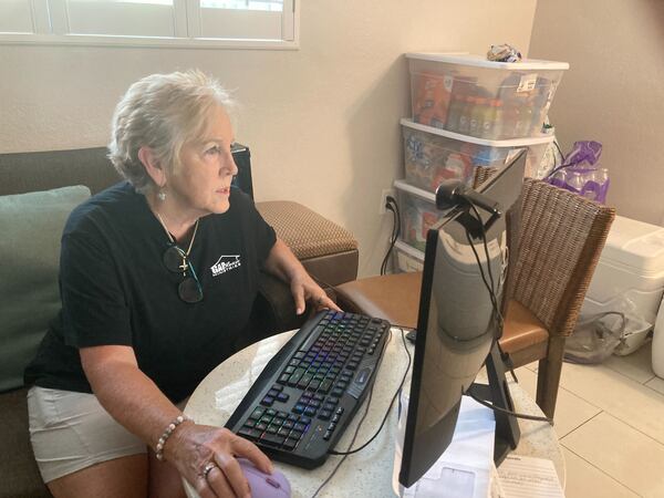 Regina Hunter, founder and executive director of GAP House Ministries, works in a makeshift office in Jekyll Island, Georgia on Thursday April 30, 2026. More than a dozen people evacuated the organization's premises in Brantley County on April 21 because of the Highway 82 wildfire. (Adam Van Brimmer/AJC)
