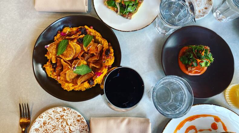 Roasted carrot dip (left), seared halloumi (top) and Hasselback potato bravas are among the appetizers offered at Rwby in Midtown. Courtesy of Rwby