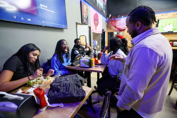 George Wright interacts with employees and customers as the bar returns to normal. (Miguel Martinez/ AJC)
