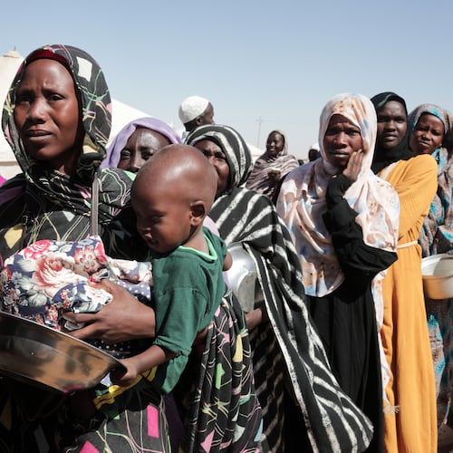 FILE - Women displaced from El-Fasher stand in line to receive food aid at the newly established El-Afadh camp in Al Dabbah, in Sudan's Northern State, Nov. 16, 2025. (AP Photo/Marwan Ali, File)