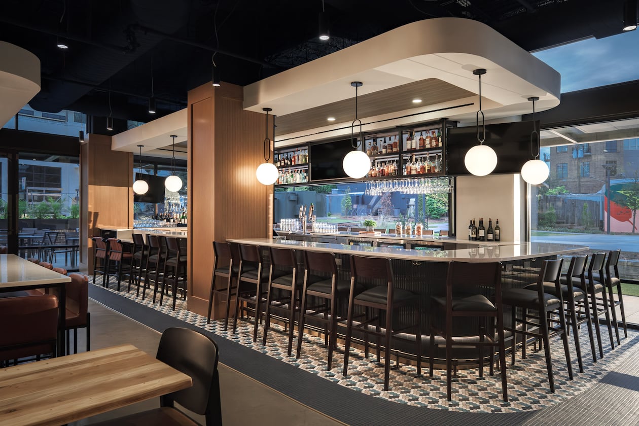 An indoor/outdoor bar is the central feature of Confab's dining room in Brookhaven. (Courtesy of Niles Bolton/Rand Construction)