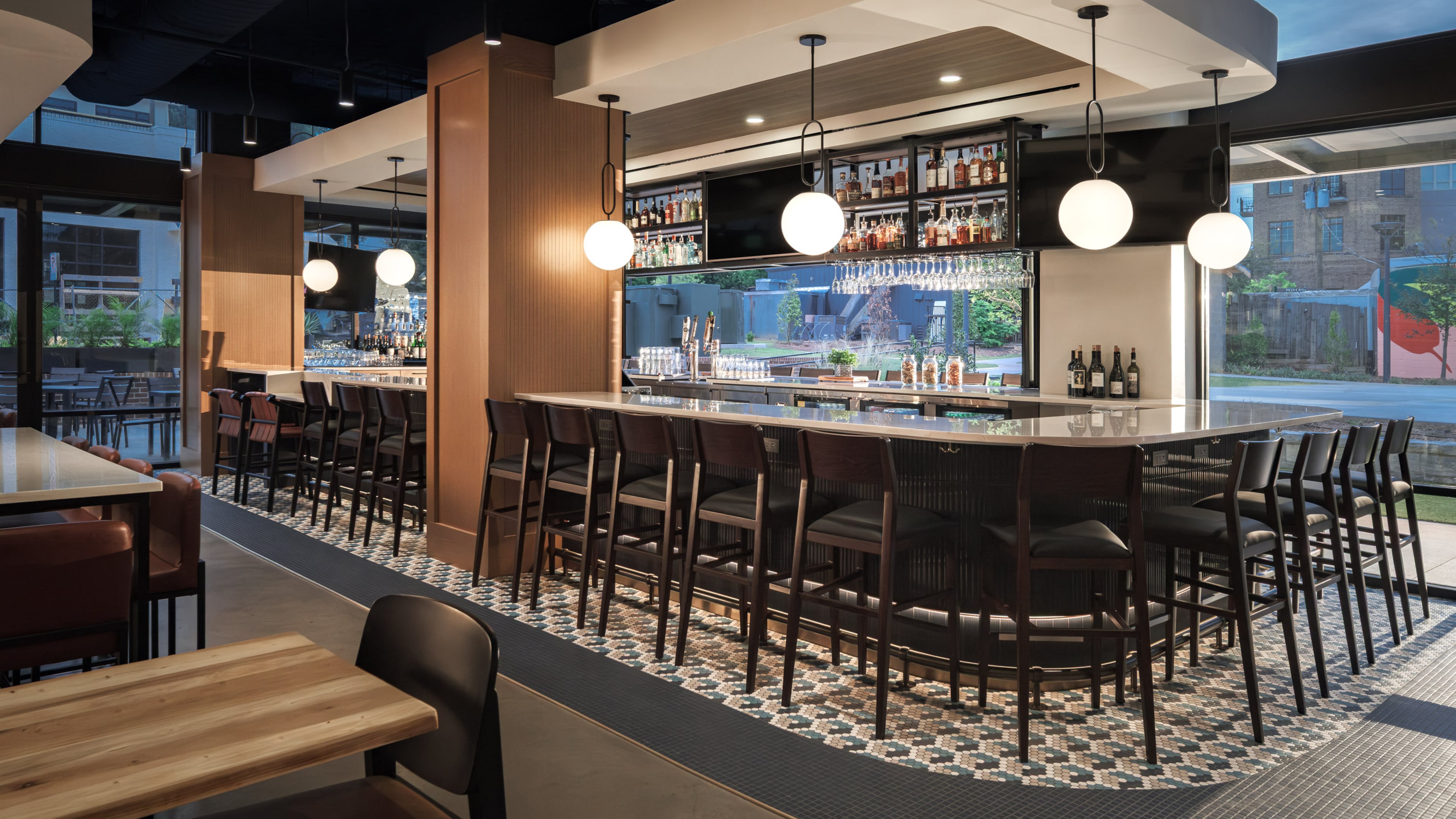 An indoor/outdoor bar is the central feature of Confab's dining room in Brookhaven. (Courtesy of Niles Bolton/Rand Construction)