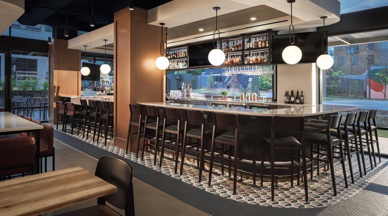 An indoor/outdoor bar is the central feature of Confab's dining room in Brookhaven. (Courtesy of Niles Bolton/Rand Construction)