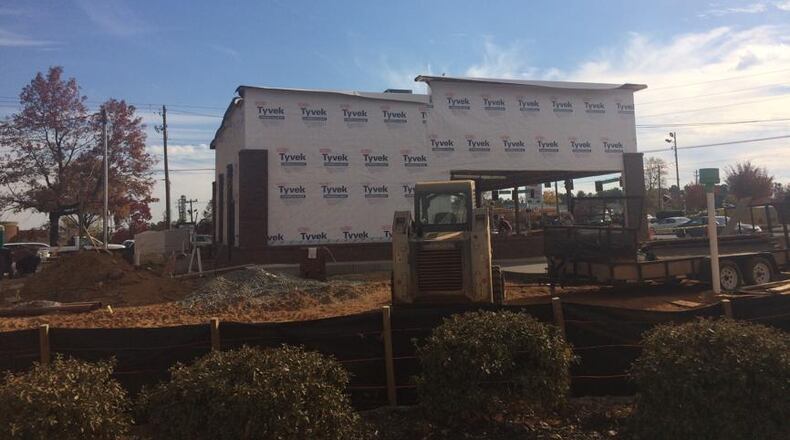 The building going up on Holcomb Bridge Road is positioned in a high-traffic location.