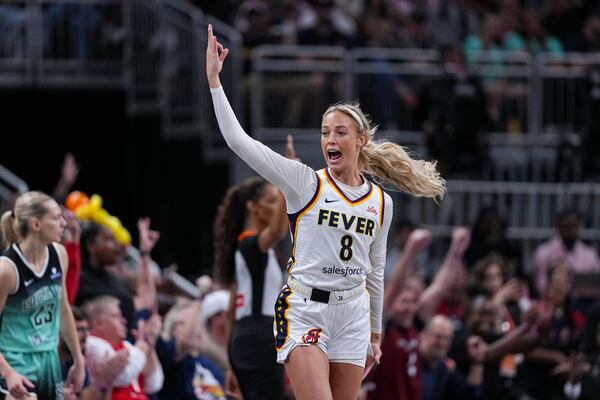 Indiana Fever guard Sophie Cunningham (8) celebrates after a three-point basket against the New York Liberty in the first half of a WNBA basketball game in Indianapolis, Saturday, May 24, 2025. (AP Photo/Michael Conroy)