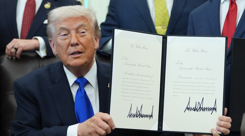 President Donald Trump signs documents regarding the withdrawal of the current nomination and nomination of a new surgeon general in the Oval Office of the White House, Thursday, April 30, 2026, in Washington. (AP Photo/Alex Brandon)