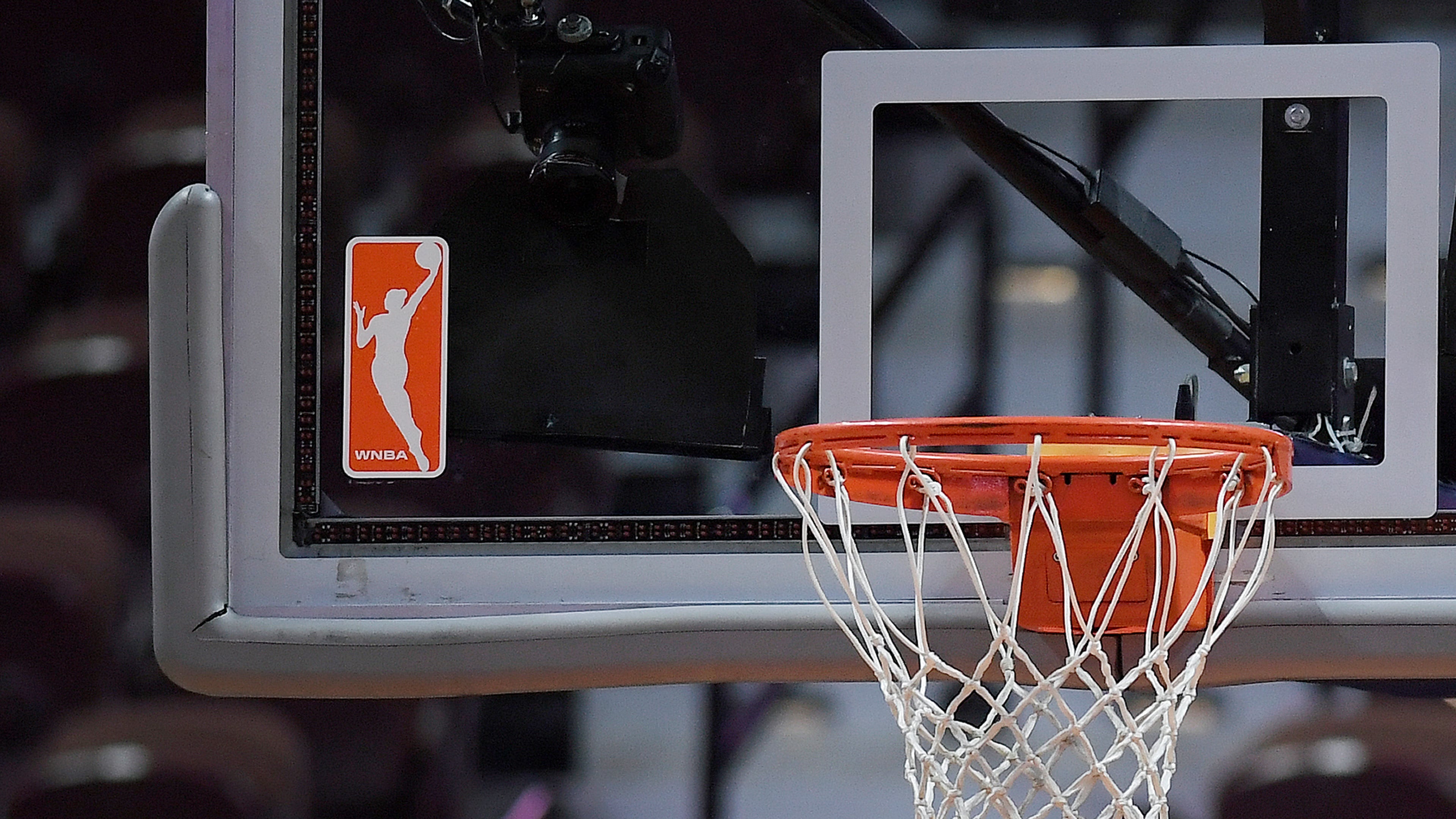 FILE - The WNBA logo and hoop are seen at a WNBA basketball game at Mohegan Sun Arena, Tuesday, May 14, 2019, in Uncasville, Conn. (AP Photo/Jessica Hill, File)