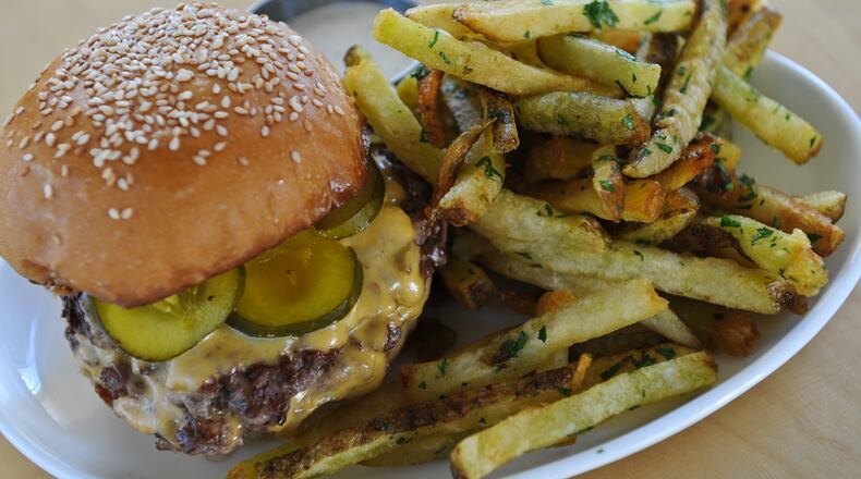 Bocado burger stack, American cheese, house made B&B pickles and garlic herb fries from Bocado.