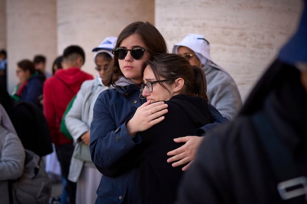 Faithful react during the funeral of Pope Francis in St. Peter's Square at the Vatican, Saturday, April 26, 2025. (AP Photo/Emilio Morenatti)