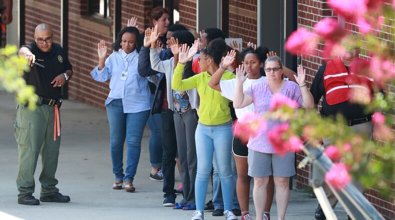 July 25, 2018 Winston: Students and teachers are evacuated during an active shooter training exercise held by the Douglas County Sheriff's Office at Mason Creek Middle School. The large-scale training drill tested the resources of area law enforcement and emergency responders to prepare Douglas County for a mass casualty active shooter event. It’s one of many strategies to address school safety. In Cobb County, high school staff have been outfitted with personal panic buttons. Curtis Compton/ccompton@ajc.com