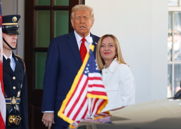 President Donald Trump, center, greets Italy's Prime Minister Giorgia Meloni, right, upon her arrival at the White House, Thursday, April 17, 2025, in Washington. (AP Photo/Tom Brenner)
