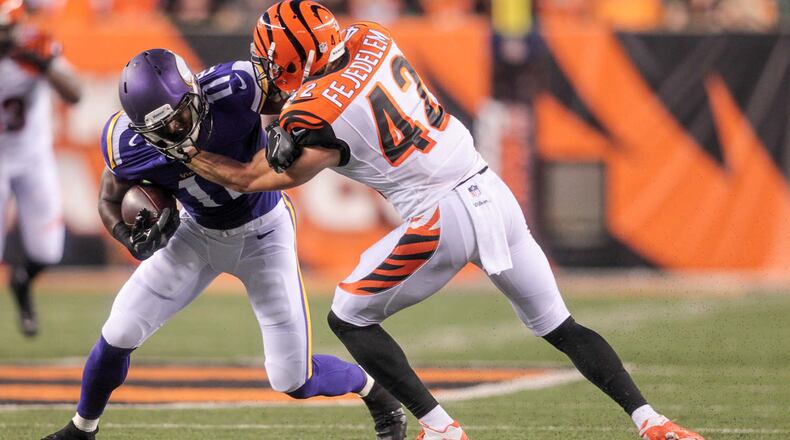 Cincinnati Bengals safety Clayton Fejedelem defends Minnesota Vikings receiver Laquon Treadwell during the second quarter of their first pre-season game against the Friday, Aug. 12, 2016, at Paul Brown Stadium in Cincinnati.
