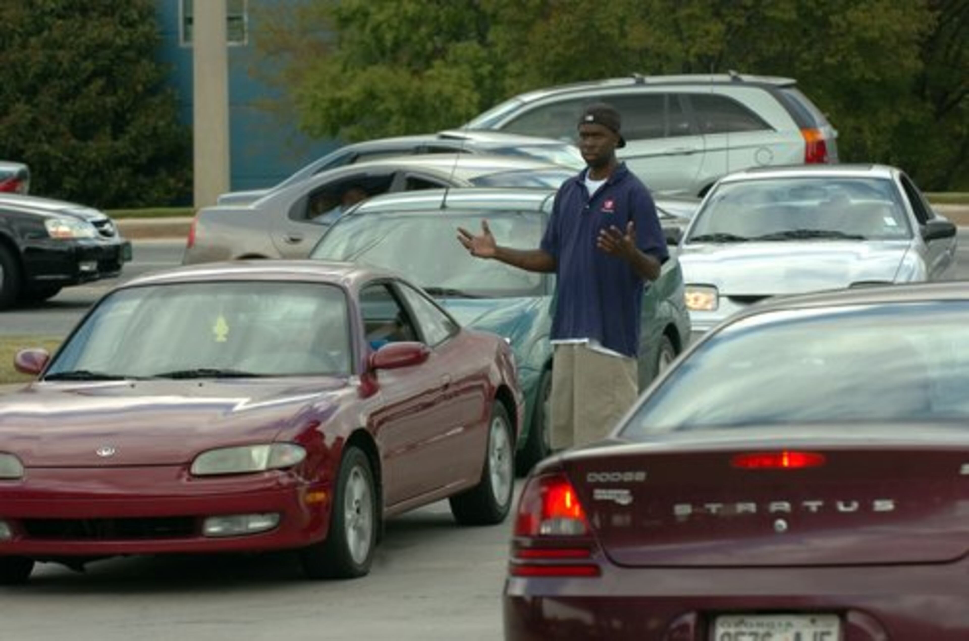 QuikTrip employee Jonathan Wright tries to find an open pump as traffic backs up on Panoia Road in south DeKalb County.