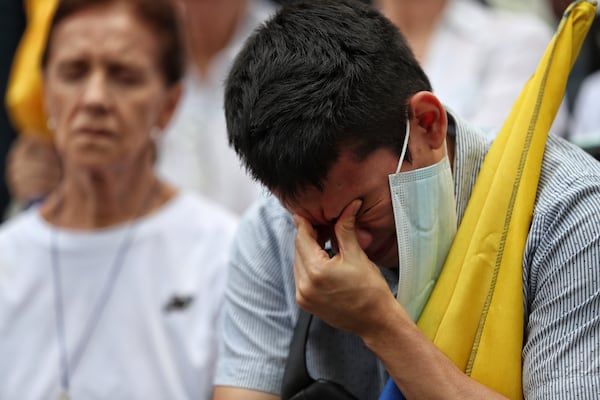 A man prays for Colombian Senator Miguel Uribe Turbay's recovery after he was shot at a political rally, in Cali, Colombia, Sunday, June 8, 2025. (AP Photo/Santiago Saldarriaga)