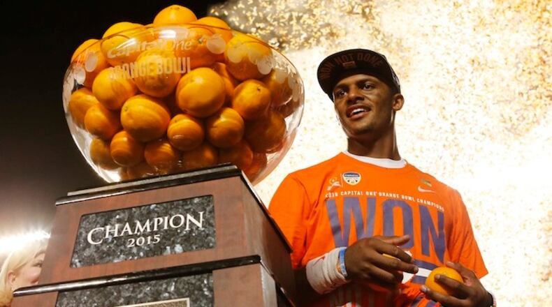 Clemson quarterback Deshaun Watson (4) poses with the Orange Bowl trophy following an NCAA college football semifinal playoff game against Oklahoma, Thursday, Dec. 31, 2015, in Miami Gardens, Fla. Clemson defeated Oklahoma 37-17. (AP Photo/Joe Skipper)